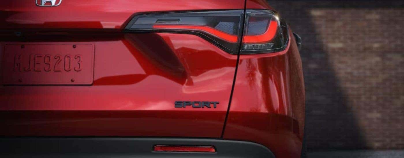 A close-up on the taillight of a red 2024 Honda HR-V Sport.