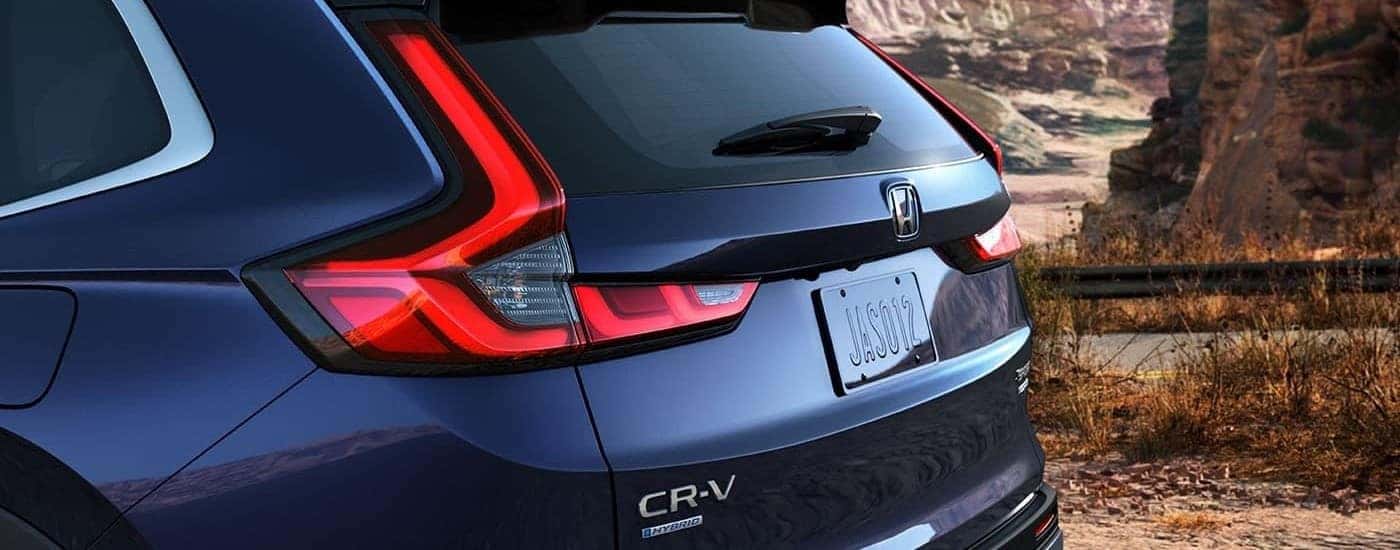 Close-up on the taillight of a dark blue 2023 Honda CR-V Sport Touring Hybrid.