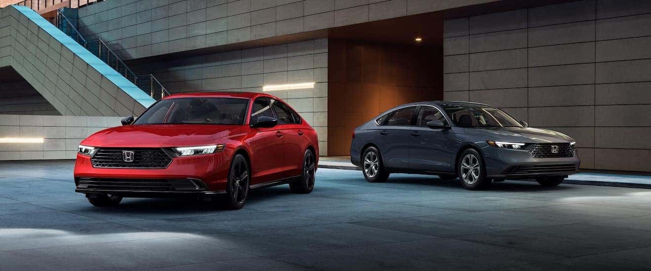 Two red and gray 2025 Honda Accord parked outside