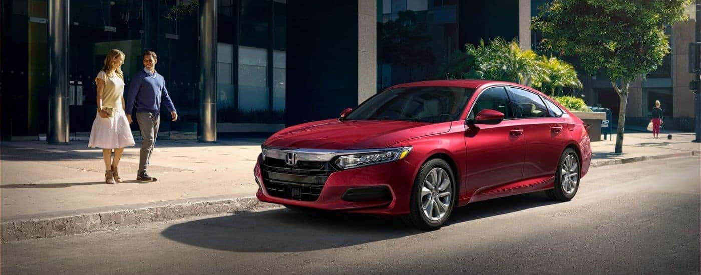 A red 2020 Honda Accord LX parked on a city street.