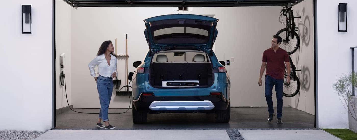 A blue 2025 Honda Prologue charging in a garage