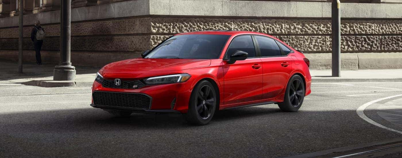 Red 2025 Honda Civic Si for sale near East Hartford driving around a bend.