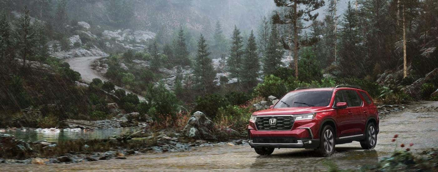 A red 2025 Honda Pilot for sale from the front at an angle.