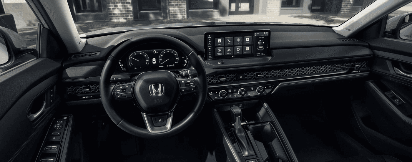 Black interior of a 2025 Honda Accord for sale near Coventry showing the digital gauge cluster and infotainment system