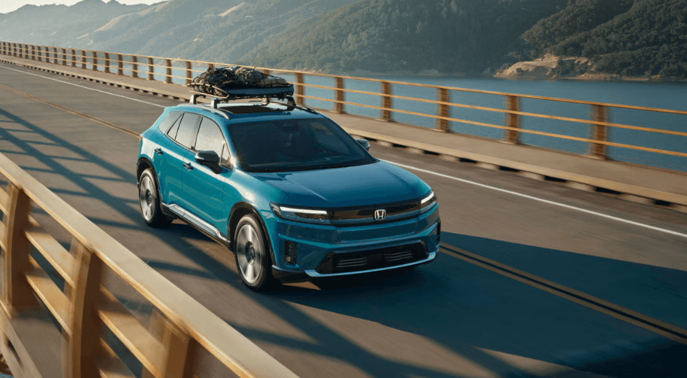 Blue 2026 Honda Prologue driving over a bridge