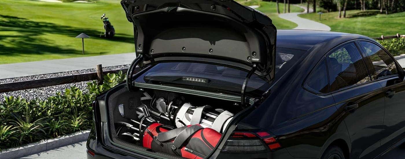Golf gear in the trunk of a black 2026 Honda Accord