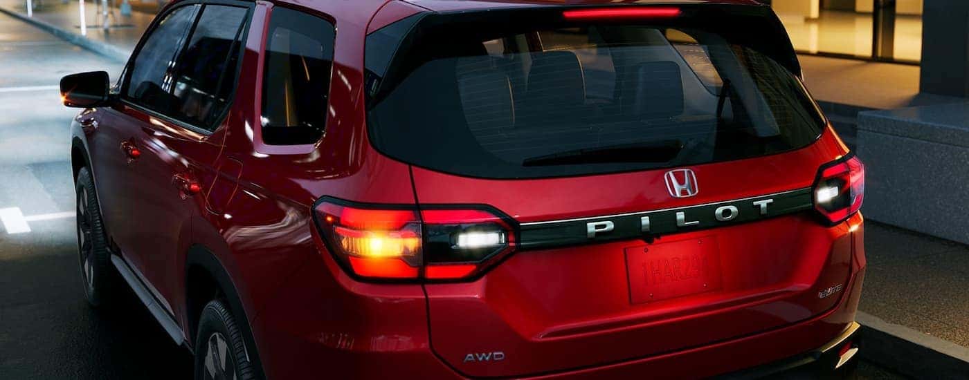 Rear of a red 2026 Honda Pilot parked at night