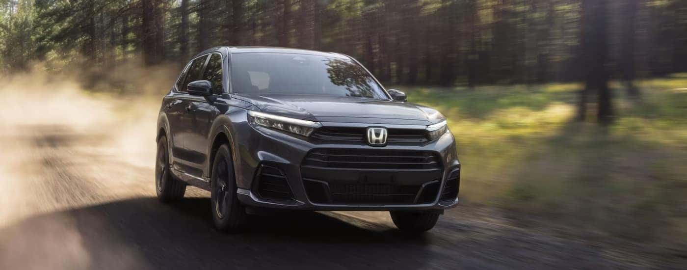 Black 2026 Honda CR-V driving down a trail