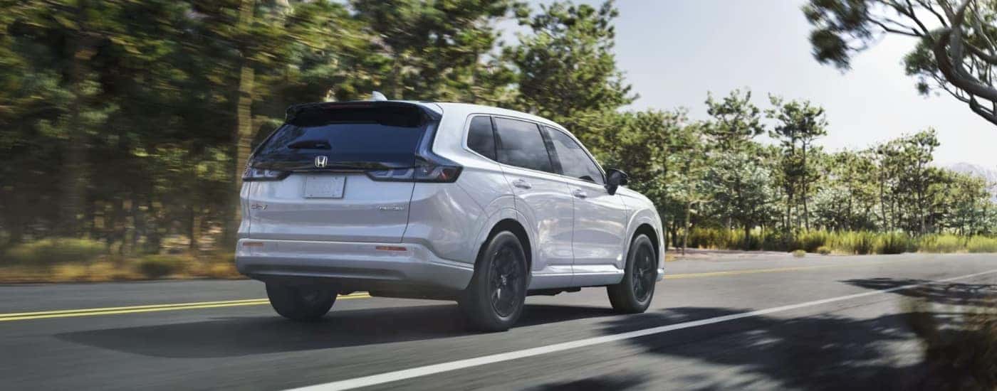 White 2026 Honda CR-V driving along an open road