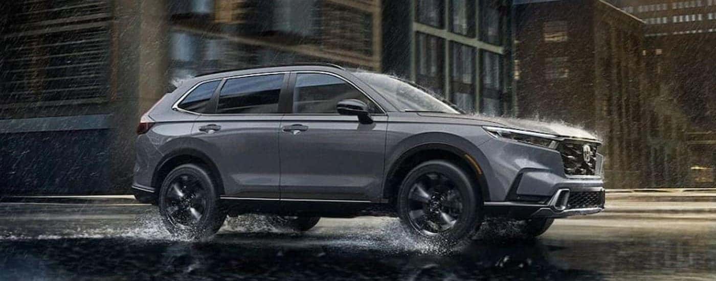 A gray 2026 Honda CR-V driving in the rain.