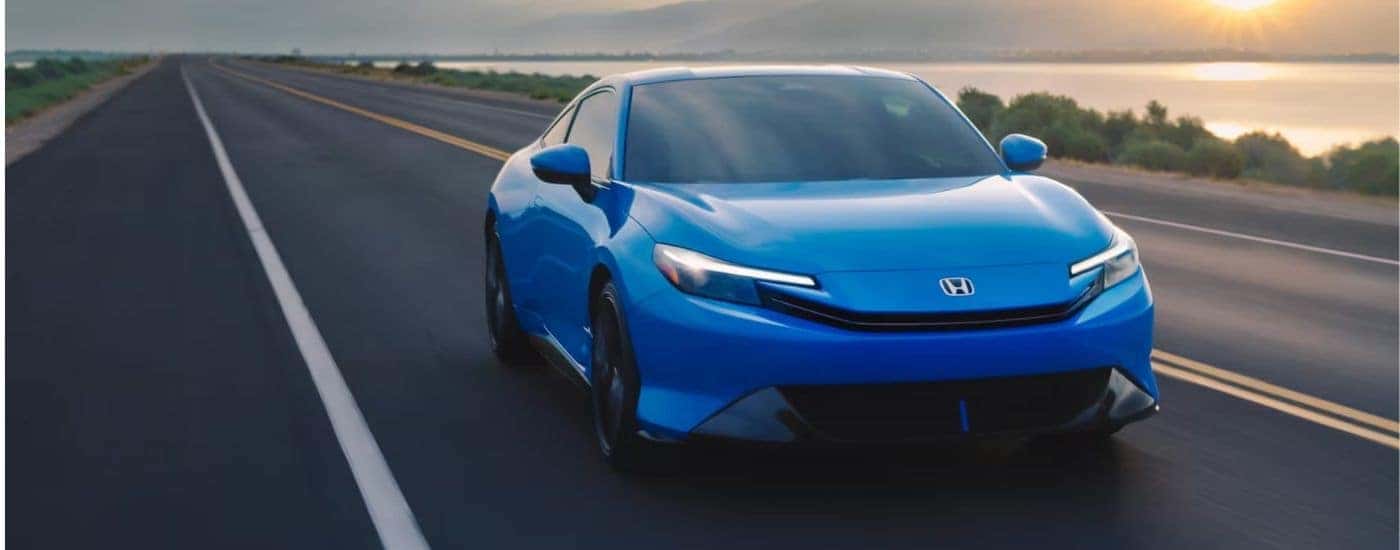 A blue 2026 Honda Prelude driving.