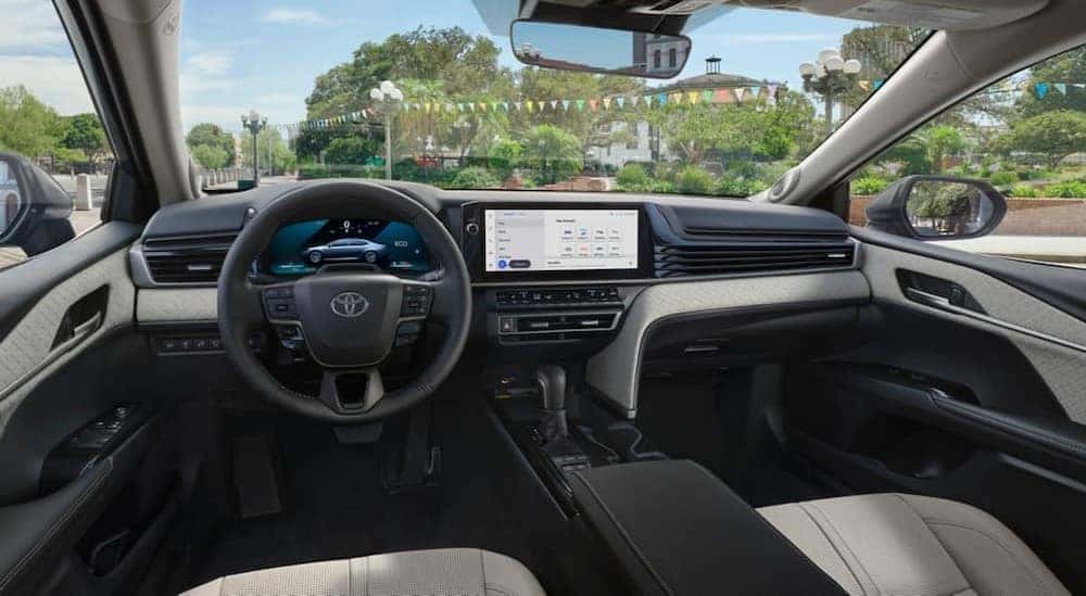 The black and white interior and dash in a 2025 Toyota Camry for sale is shown.