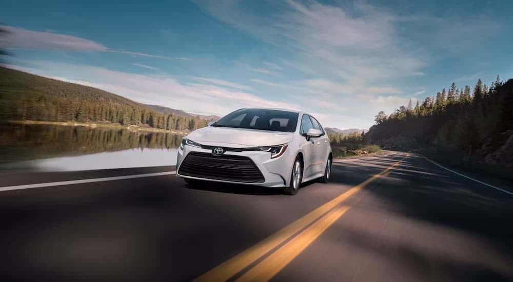 A white 2025 Toyota Corolla Hybrid for sale near Sandy Springs from the front.
