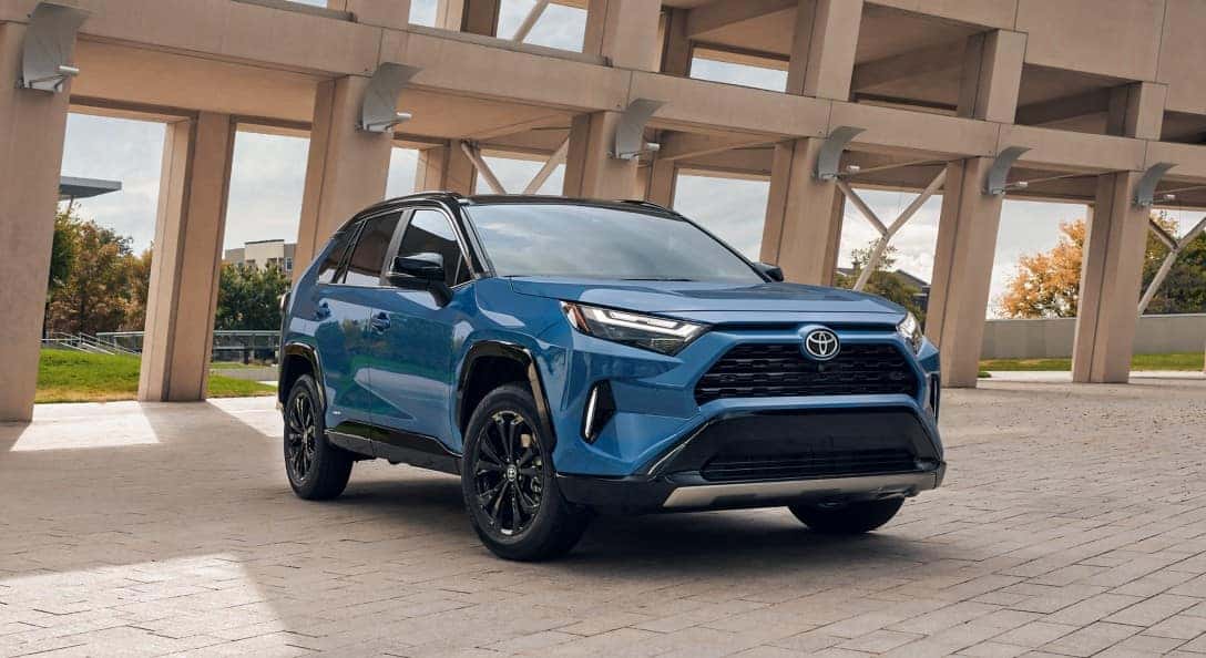 A parked blue 2025 Toyota RAV4 Hybrid