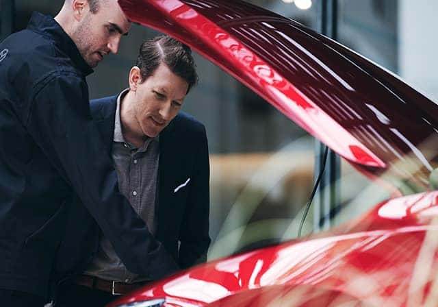 car owner bringing a vehicle in for service at a dealership