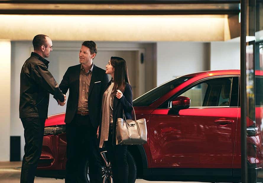 friendly car salesman helping a customer