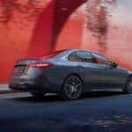 Silver 2024 Mercedes C-Class AMG model driving down a city street