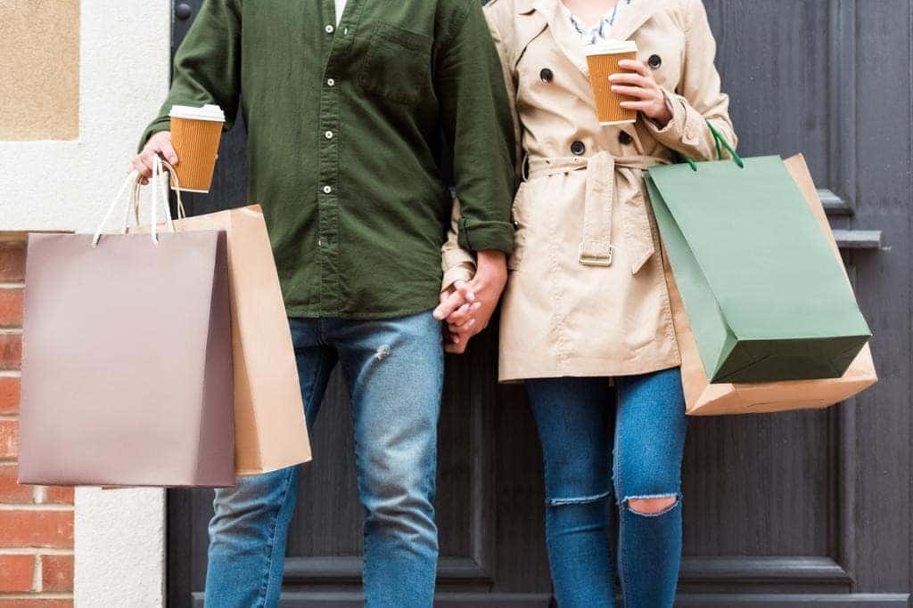 Man and woman holding shopping bags