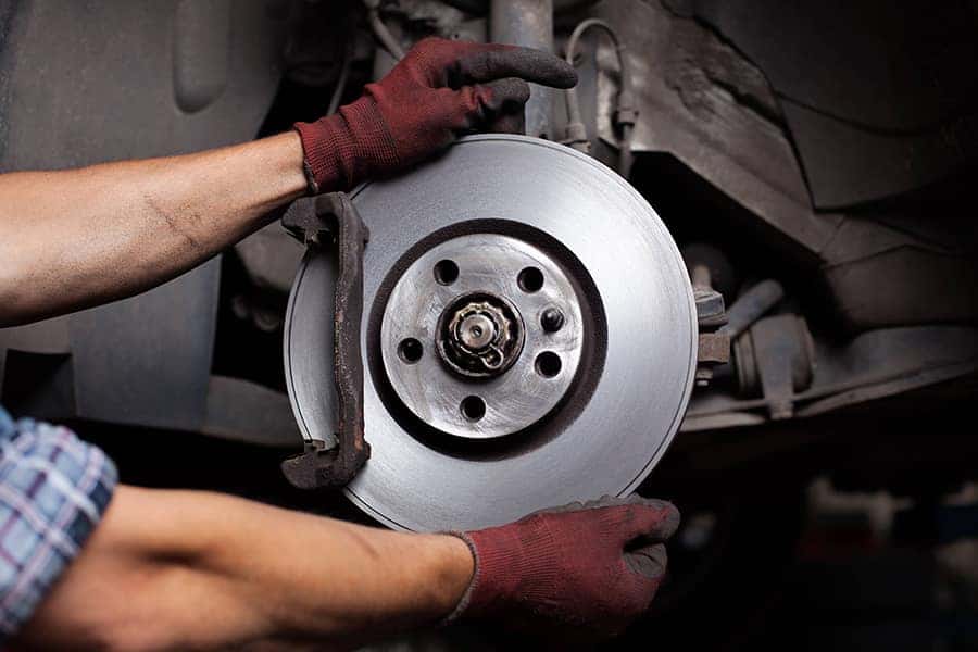 Mechanic Putting Tire on Car