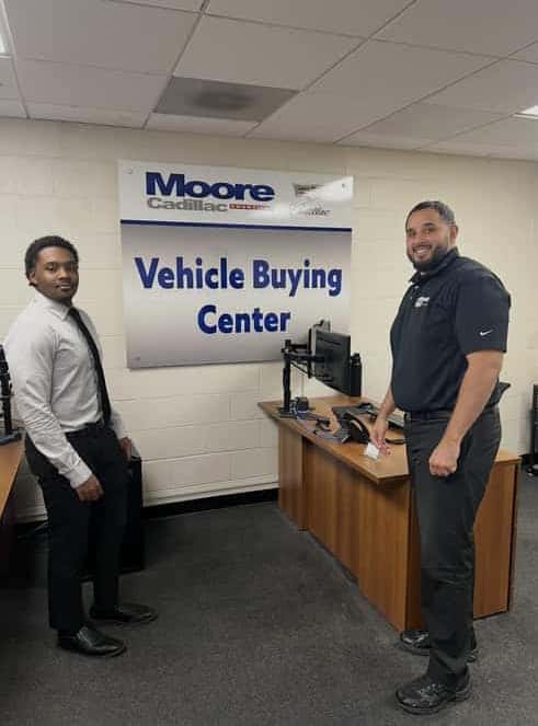 Salesman giving new car keys to customer