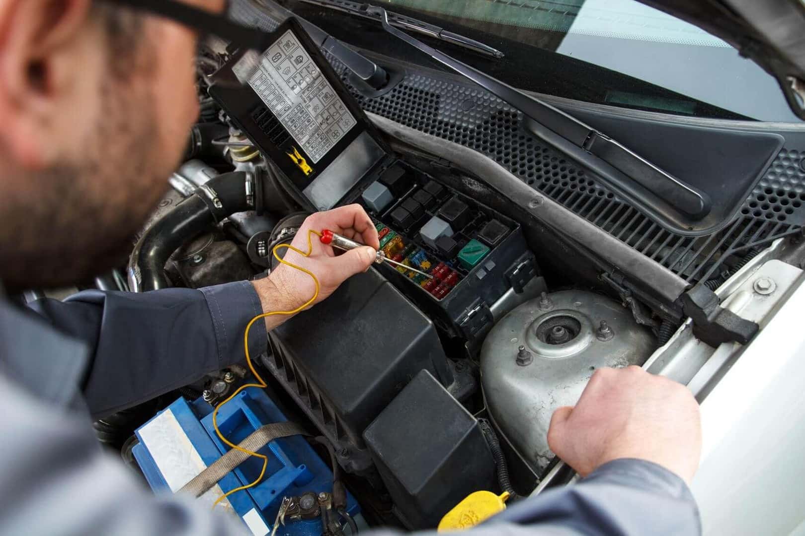Electric car technician at work