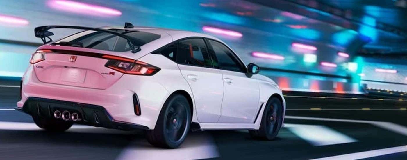 A white 2024 Honda Civic Type-R is shown driving to a Honda dealer.