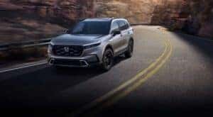 A silver 2022 Honda CR-V for sale in North Richland Hills is shown driving on a highway.