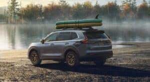 A popular Honda CR-V for sale near Grapevine, a gray 2024 Honda CR-V EX HPD Package, is shown parked near a lake.