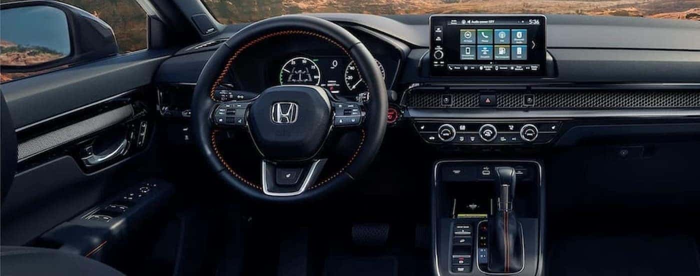 The black interior and dash are shown in a 2024 Honda CR-V.