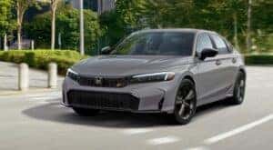 A gray 2025 Honda Civic Si is shown driving to a Honda dealer near Keller.