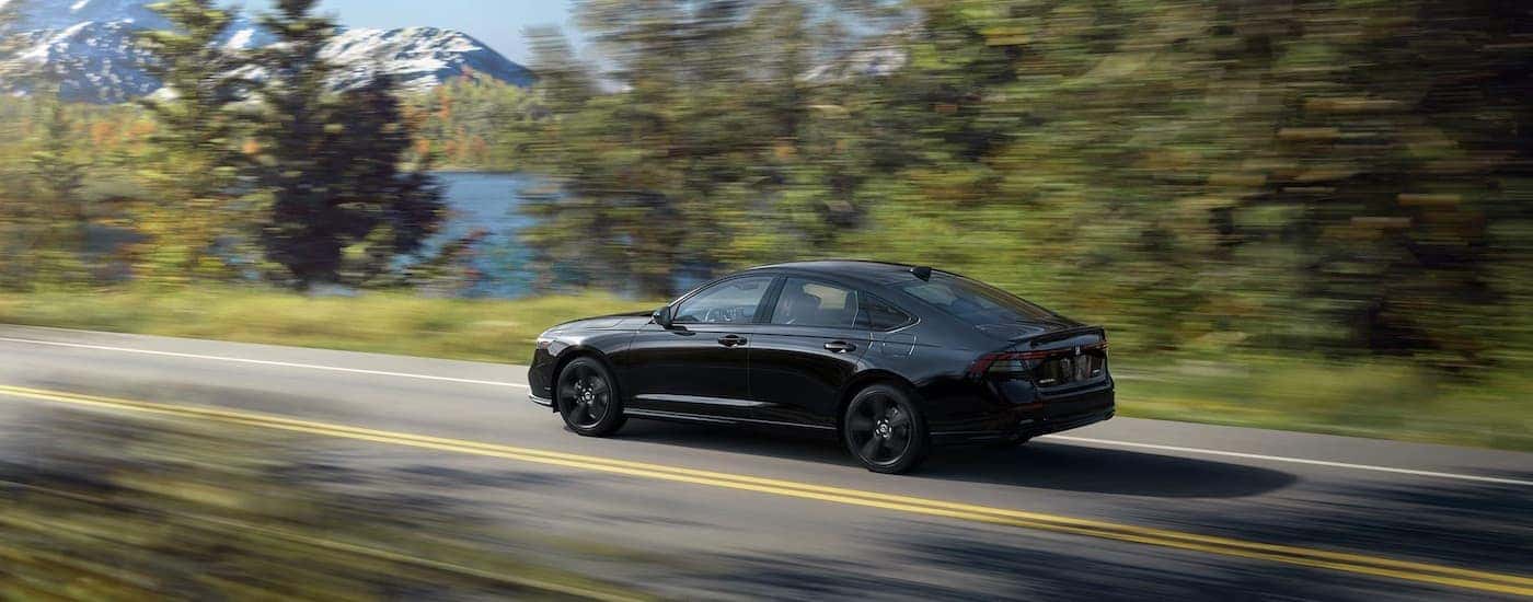 A black 2024 Honda Accord is shown from the side.
