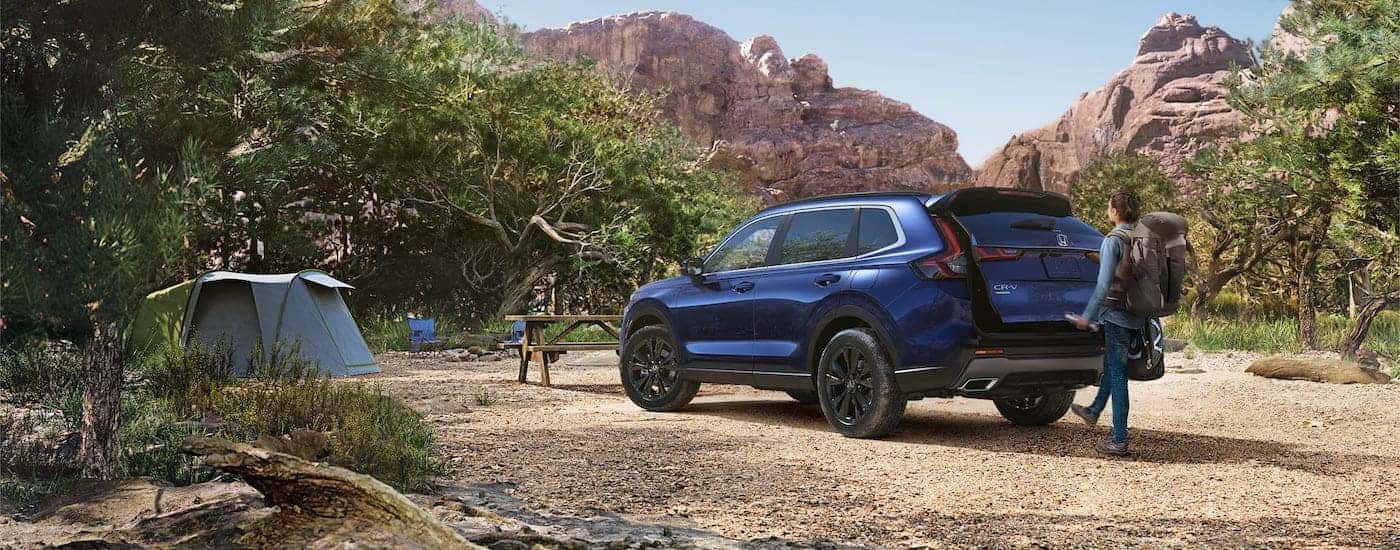 A blue 2025 Honda CR-V is shown from the rear at an angle.