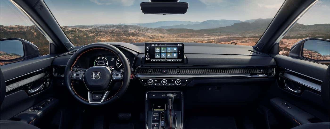 The black interior of a 2025 Honda CR-V Hybrid is shown from above the center console.