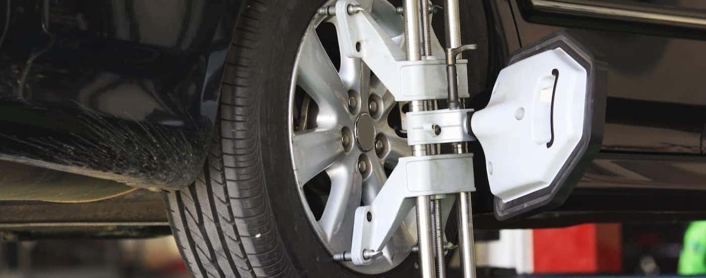 A wheel alignment is shown being performed at a Honda service center in North Richmond Hills.