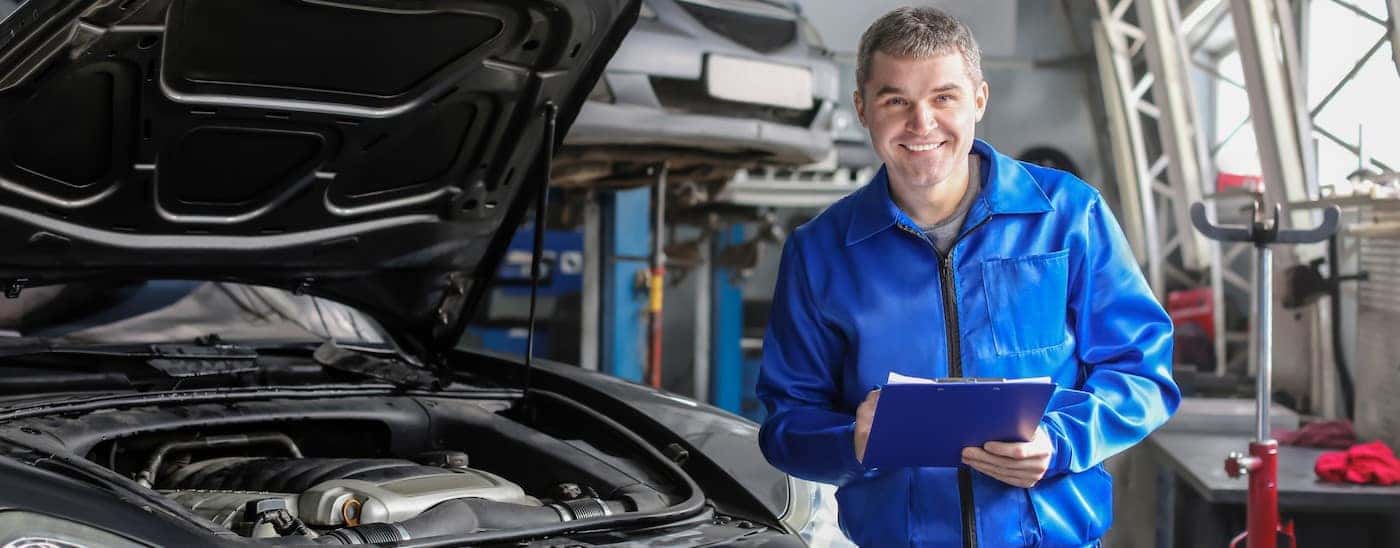 A technician is shown standing near a vehicle at a Honda service center near Fort Worth.