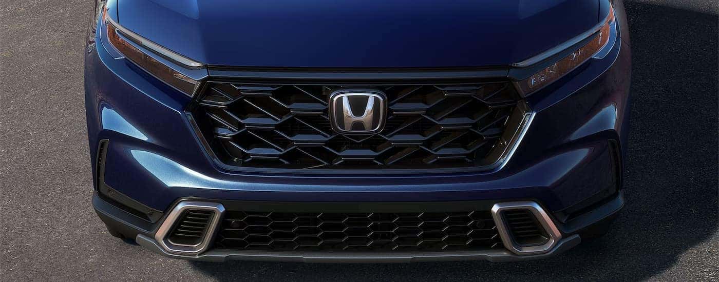 Grille and front of a blue 2025 Honda CR-V Hybrid.