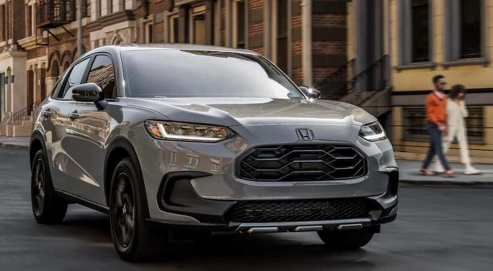 A gray 2025 Honda HR-V Sport is shown driving after viewing a Honda HR-V for sale.