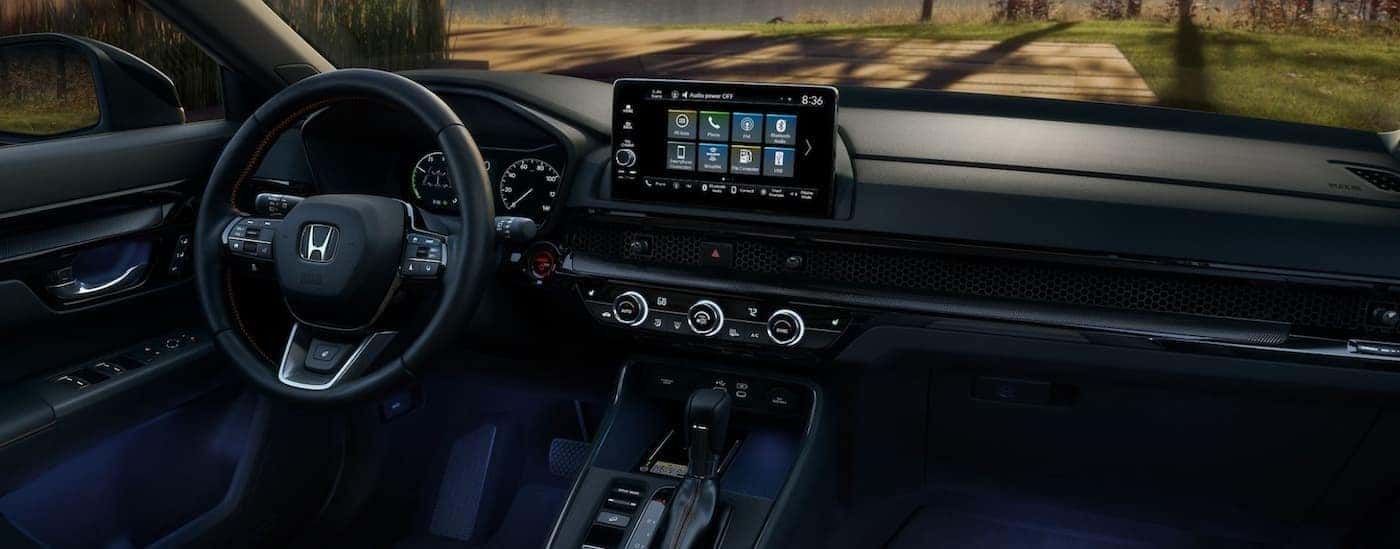 The black interior and dash are shown in a 2025 Honda CR-V Hybrid for sale near Arlington.