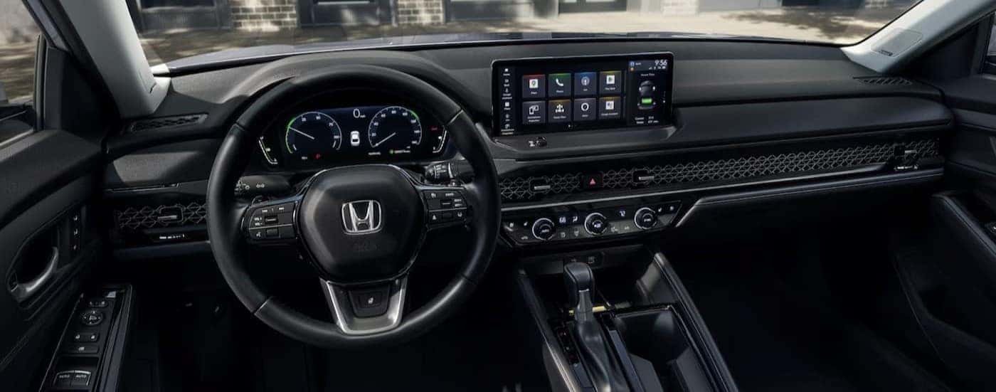The black interior and dash are shown in a 2025 Honda Accord Hybrid for sale near Arlington.