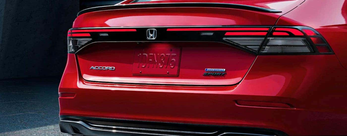 The rear end of a red 2025 Honda Accord Hybrid Sport-L.