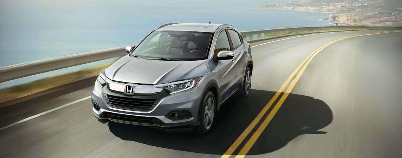 A grey 2021 Honda HR-V for sale near Keller driving down a road.