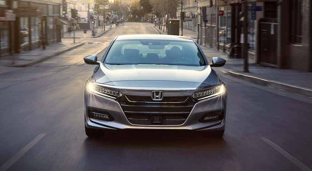 A silver 2020 Honda Accord driving to view a used Honda for sale.