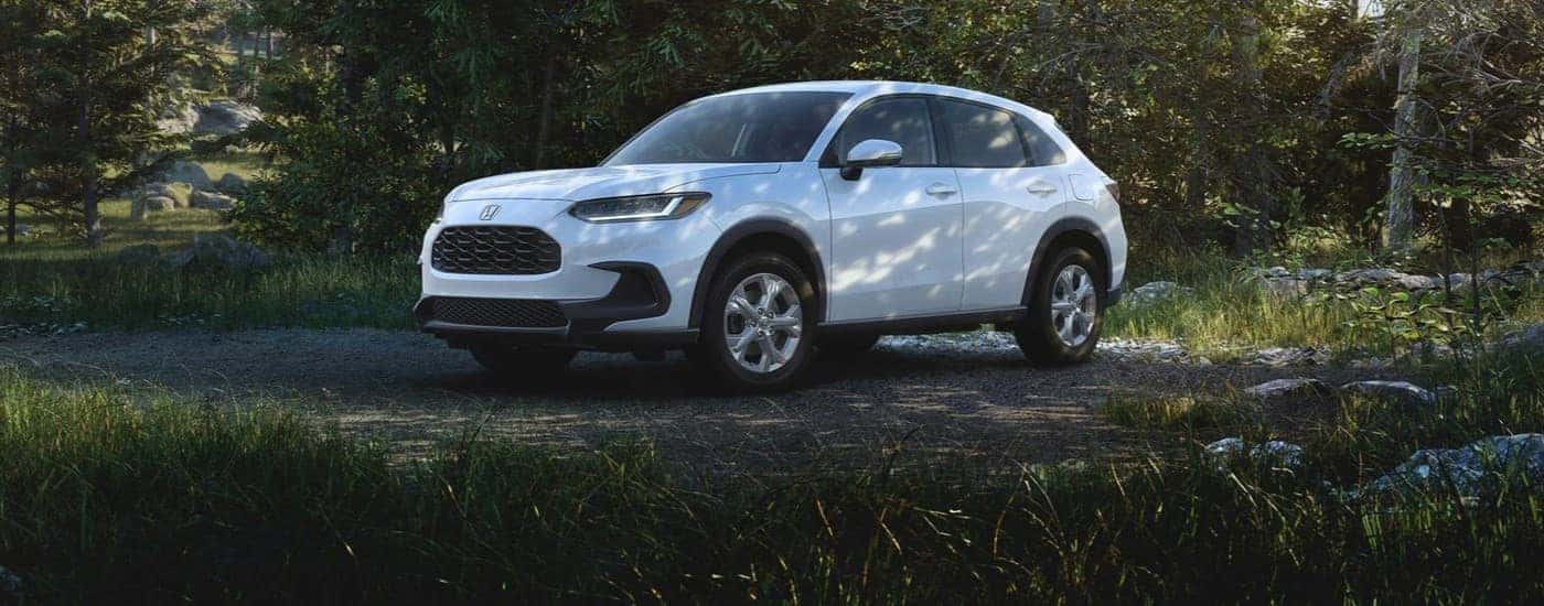 A white 2024 Honda HR-V parked off-road.