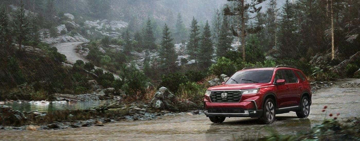 A red 2025 Honda Pilot is shown driving to a Honda dealer in North Richland Hills.