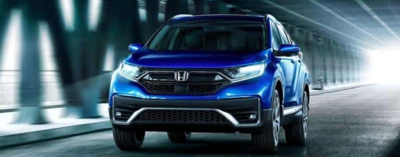 A blue 2020 Honda CR-V for sale near Colleyville driving through a tunnel.