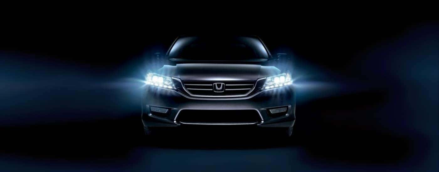 A grey 2015 Honda Accord against a black background.