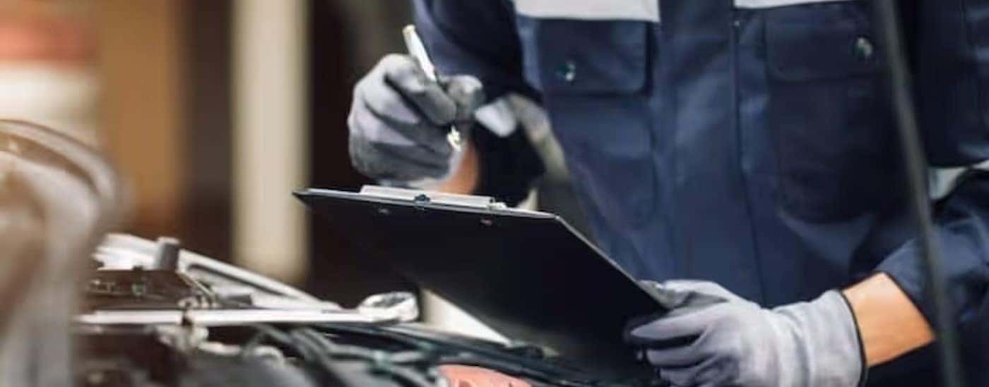 A technician holding a clipboard at a Honda Service Center in North Richland Hills.