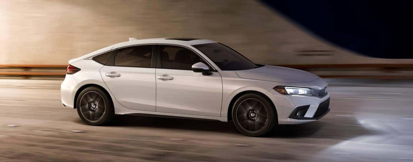 A white 2022 Honda Civic is driving to a Honda dealer near Grapevine.
