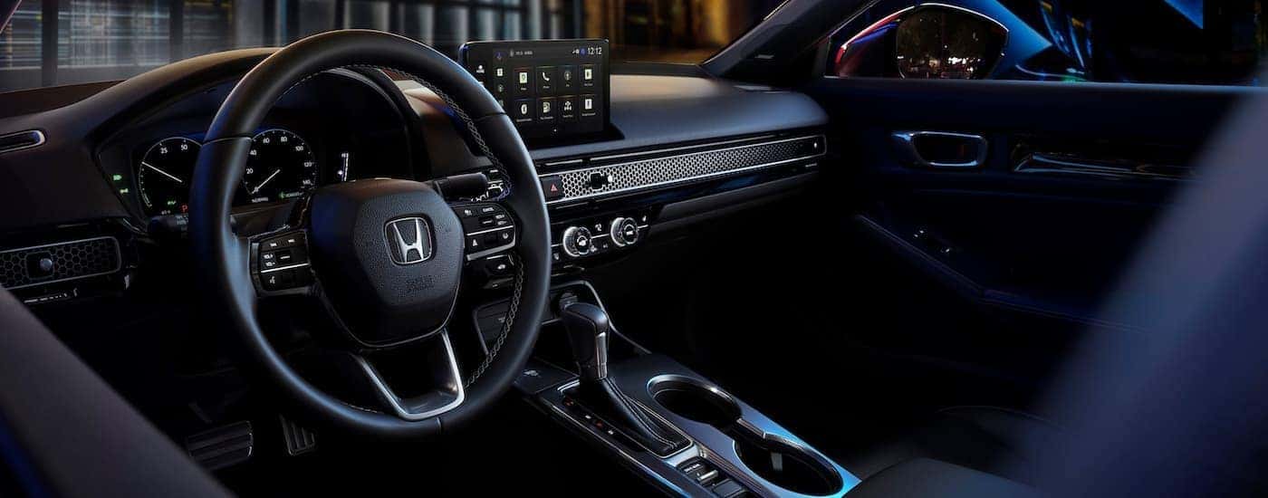 Steering wheel and dashboard in the interior of a 2026 Honda Civic.