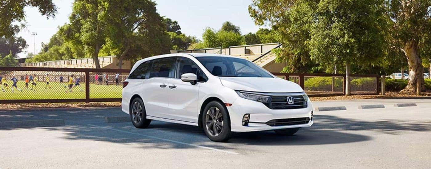 A white 2023 Honda Odyssey for sale near Colleyville parked near a soccer field.